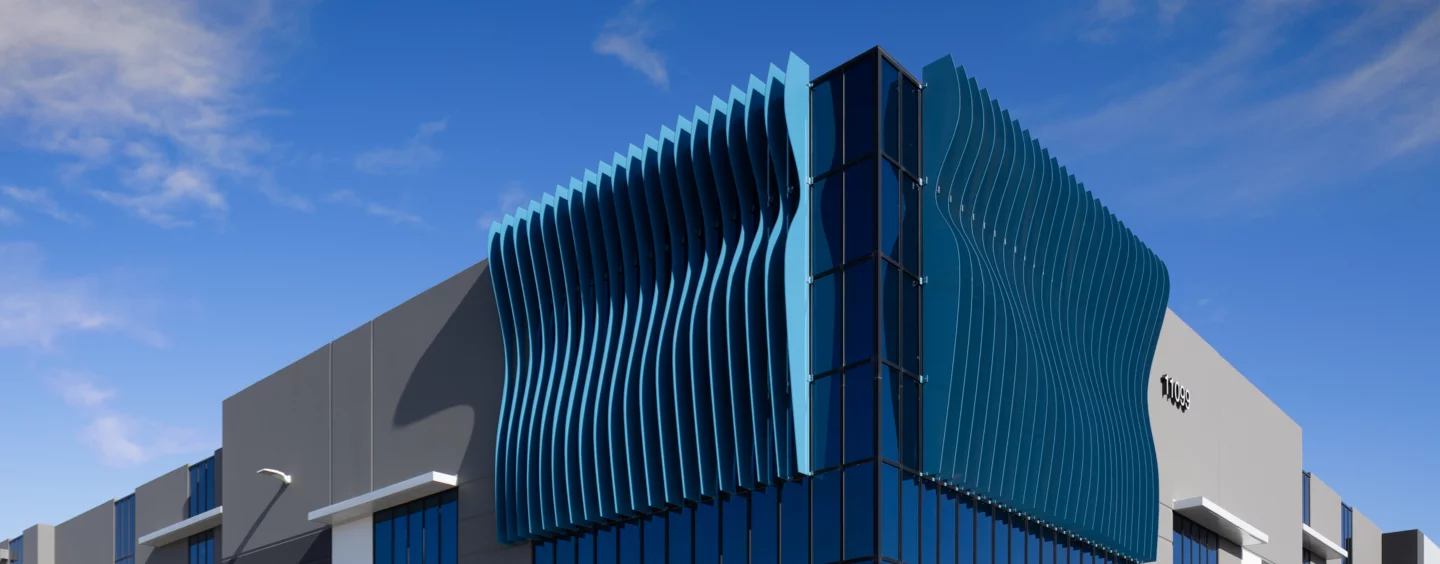 Exterior Almond Avenue, contemporary design, abstract blue wave at top of building, front entrance under blue wave, photo taken on a sunny day.