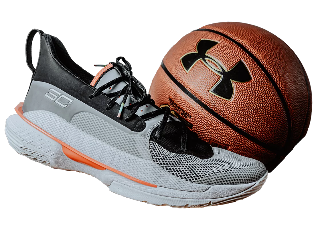 Photo of under armour shoe and basketball.