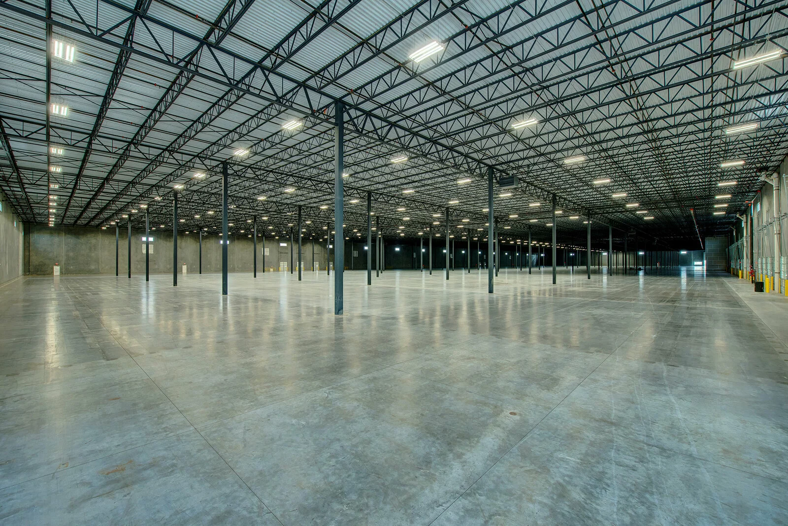 Interior Building warehouse, concrete floors, vast empty space.