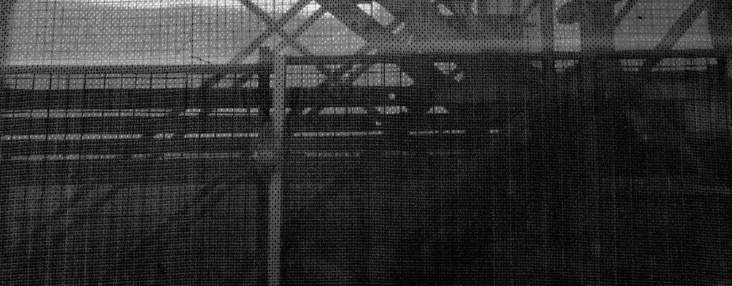 Construction mesh with and scaffolding behind it. black and white photo