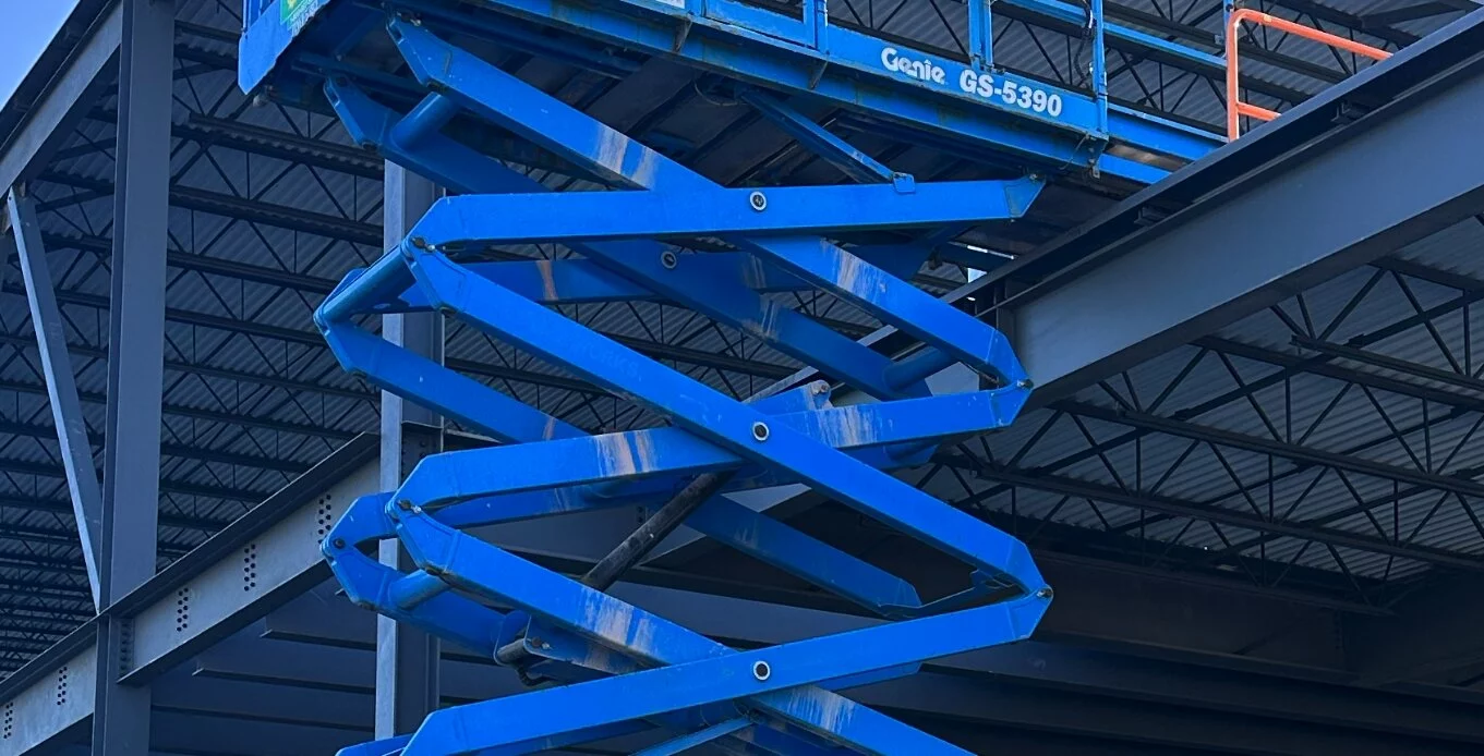 Close up photo of Scissor lift being using in contruction