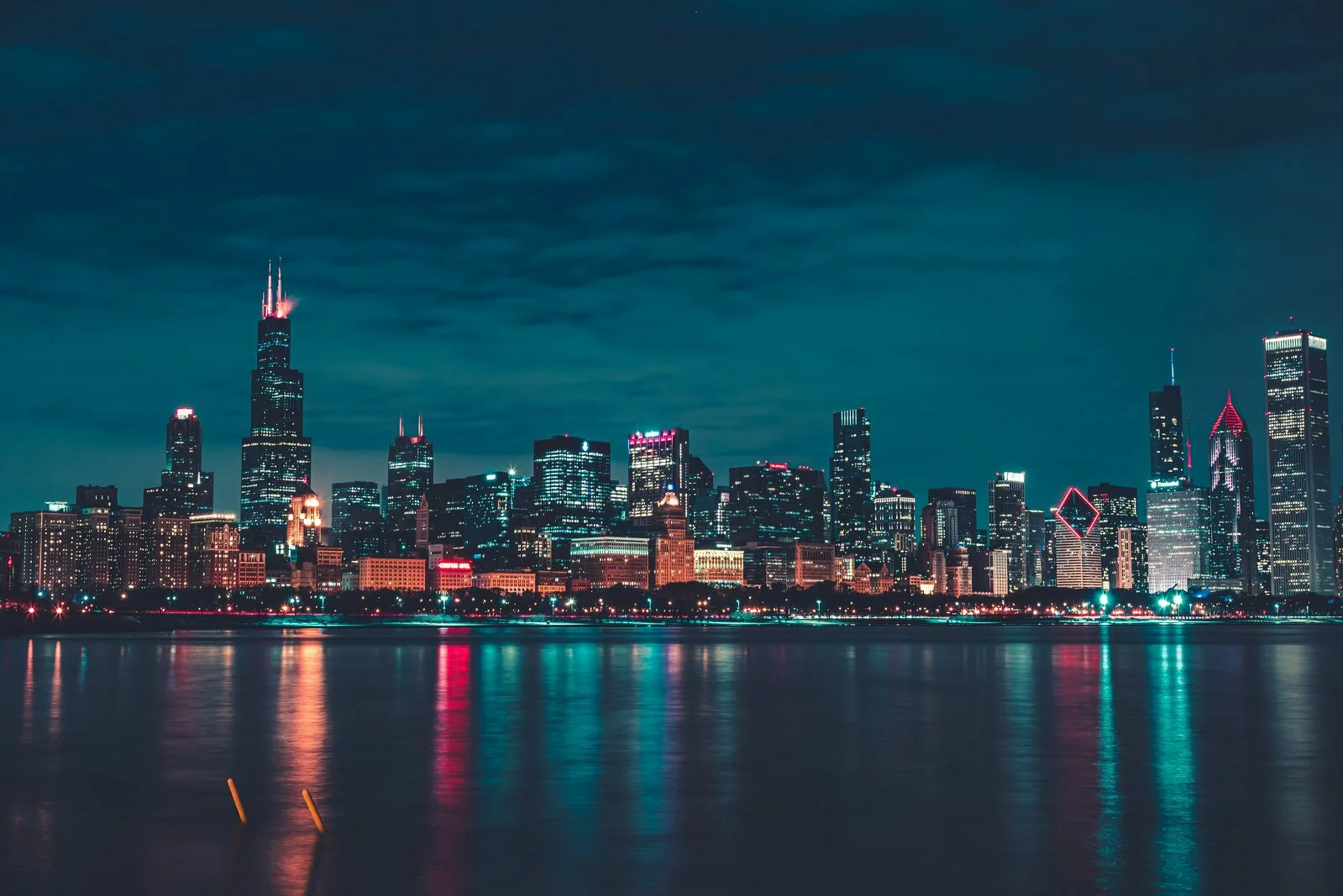 chicago skyline at dusk, city lights reflecting off lake michigan