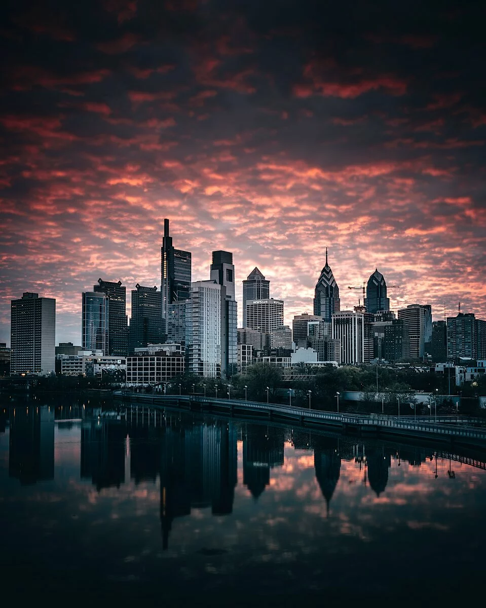 Landscape Photo of Philadelphia, skyscrapers reflecting off of body of water, skyscrapers in the distance.