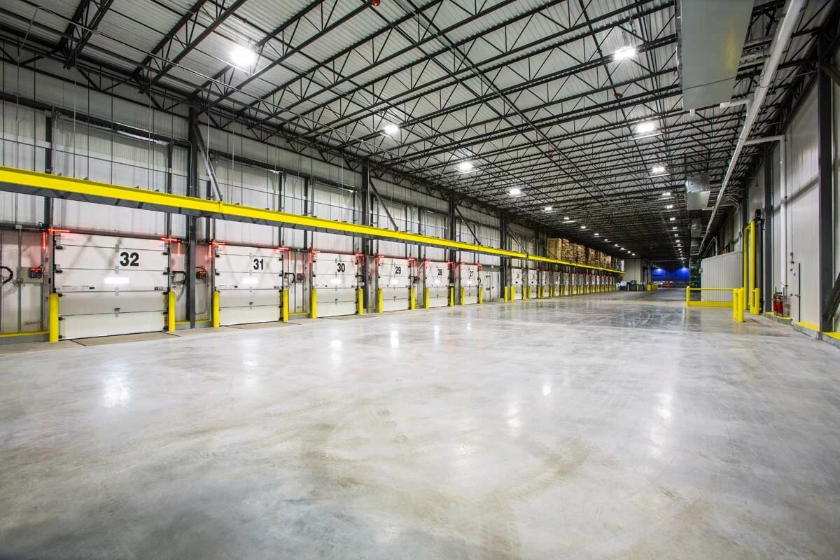 McCook Cold Storage facility, yellow elements, numbered loading bays, open floor, tall ceilings.