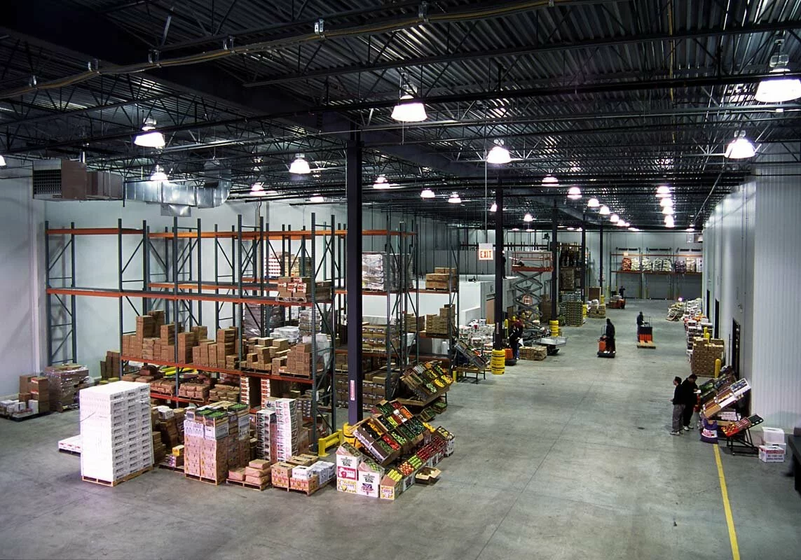 Chicago International Produce Cold storage facility interior, shelving of food and produce, boxes, warehouse employees working.