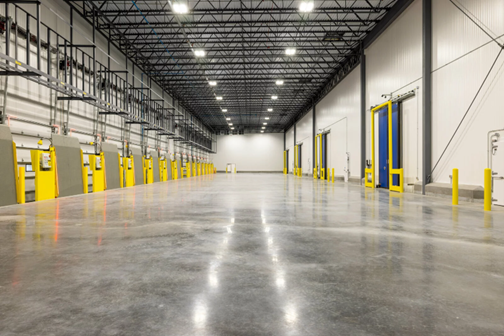 An empty Cold Summit interior with high ceilings, bright lights, and yellow and blue elements.